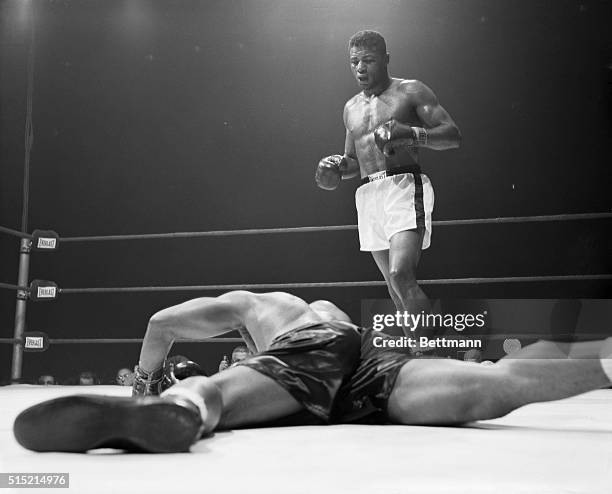 Archie Moore decorates the canvas face down after taking a left hook from Floyd Patterson in the 5th round of their heavyweight title bout. A moment...