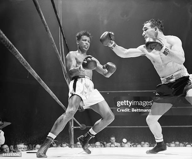 New York, NY- Sugar Ray Robinson has a look of respect as he shuns a long right thrown by Gene Fullmer in the sixth round of their middleweight title...
