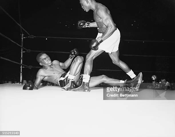 Challenger Jimmy Carter stands over Ike Williams immediately after flooring him late in the 14th round of their scheduled 15-round title bout at...