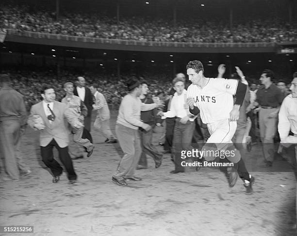 New York, NY- Bobby Thomson, surrounded by excited and worshipping fans, runs for the Giant dressing room after his pennant-winning homer in today's...