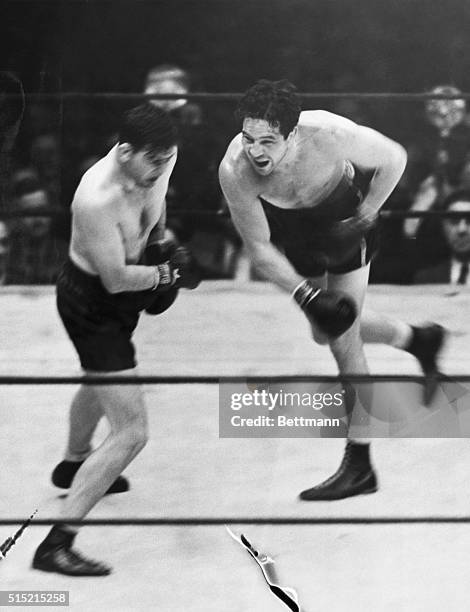 1935Jimmy Braddock wins the title from Max Baer, who is shown here missing with his famed right.