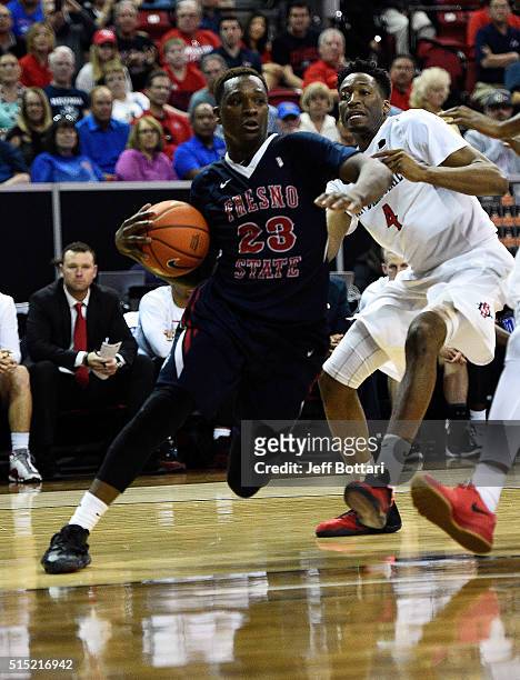 Marvelle Harris of the Fresno State Bulldogs drives to the hoop against Dakarai Allen of the San Diego State Aztecs during the championship game of...