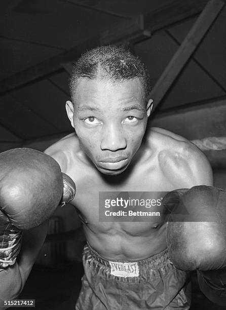 Summit, NJ- Sandy Saddler raises his gloved fists, with which he expects to beat the featherweight champion Willie Pep, when they meet in Madison...
