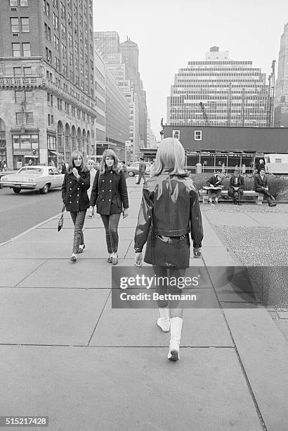 New York, NY- Model Lorna McDondough marches down Fifth Avenue, much to the interest of a pair of youthful strollers. The British model, one of 4 who...