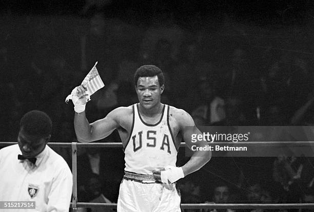 Mexico City, Mexico- George Foreman of Houston, TX, waves a small American flag after he won the Olympics heavyweight boxing gold medal to climax...