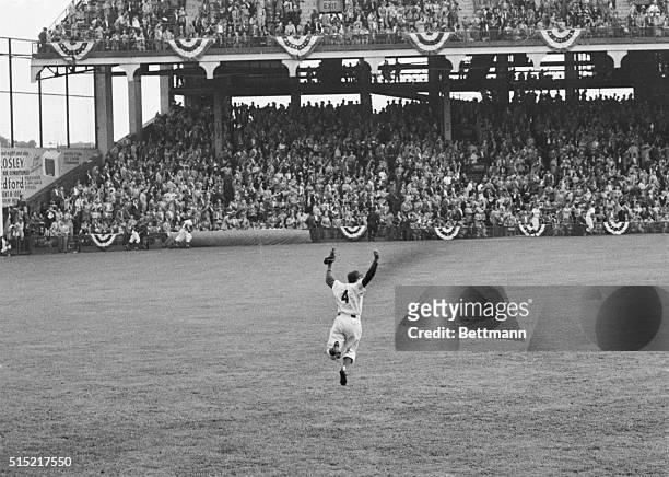 Brooklyn, NY- Dodger centerfielder Duke Snider jumps with glee before the crowded stands as teammate Joe Black strikes out Yankee Irv Noren to end...
