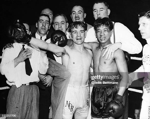 London, England- Benny Lynch , of Glasgow, and Small Montana, the Philippino, after their 15-round bout for the flyweight title at the Empire Pool,...