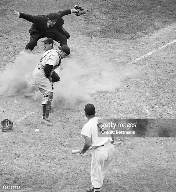 Boston, MA- With the dust hiding the plate, Ted Williams of the Red Sox slides safely home in the 5th inning of the game at Fenway Park. Williams...