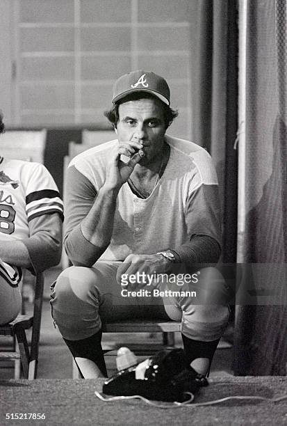 Atlanta Braves manager Joe Torre, close-up, puffs on a cigar during a rain delay of the play-off game against St. Louis.