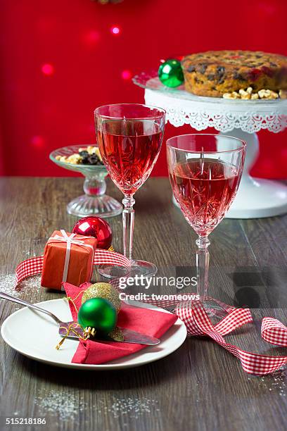 two crystal wine glasses with red wine on christmas party table top. - crystal christmas tree ornaments fotografías e imágenes de stock