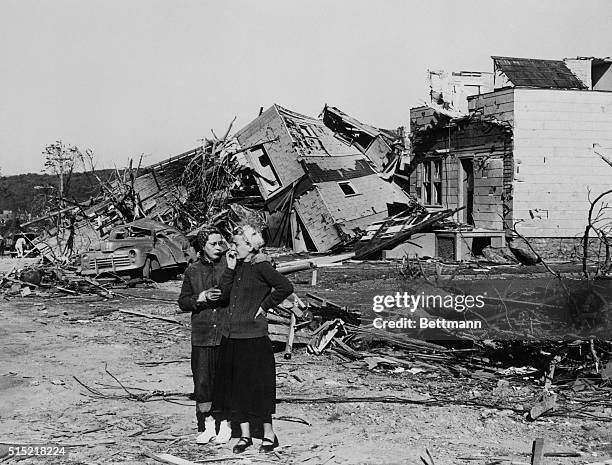 Worcester, MA- With the wreckage of her home in background, Mrs. Alice O'Donnell weeps over her loss while her neighbor, Mrs. Florence Long tries to...