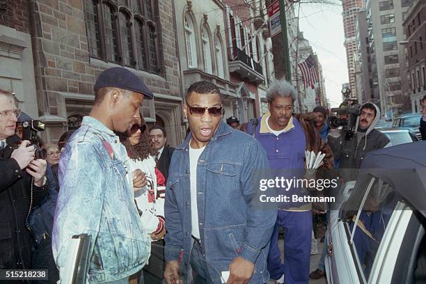 New York, New York- Just back from Tokyo where he was kayoed by James Douglas, Mike Tyson is followed by promoter Don King as they leave King's...