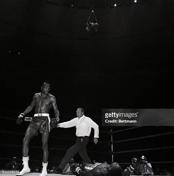 New York, NY- Challenger Bob Foster is motioned to a neutral corner by referee Mark Conn after decking light-heavyweight champion Dick Tiger in...