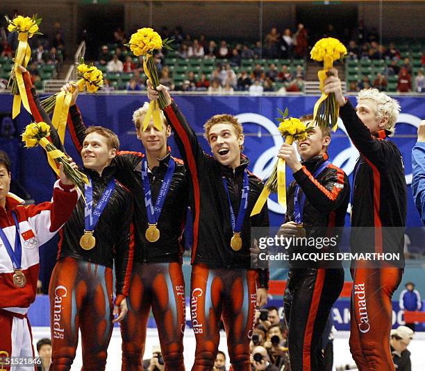 Canadian teammates and gold medalists Eric Bedard, Mathieu Turcotte, Frantois-Louis Tremblay, Jonathan Guilmette and Marc Gagnon jubilate on the...