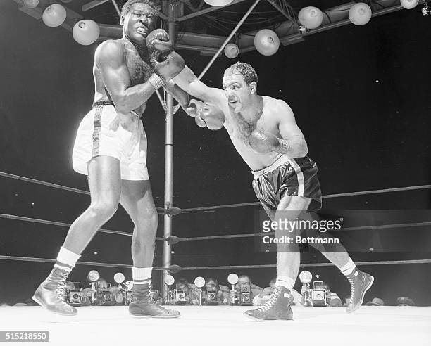 New York, NY-This was the big punch that weakened challenger Ez Charles for his 8th round slaughter. Moments after Champ Rocky Marciano landed the...