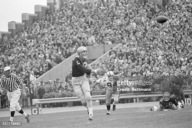 Philadelphia, Pennsylvania- Roger Staubach, , just gets off his pass to halfback Tom Leiser just in time as Army end Tom Schwartz, , barrels down on...