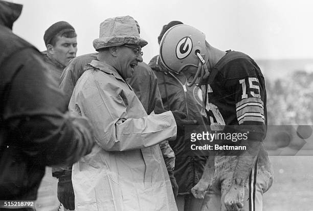 Green Bay Packers coach Vince Lombardi manages a smile near the end of NFL title game against the Cleveland Browns. Lombardi is talking to his QB...