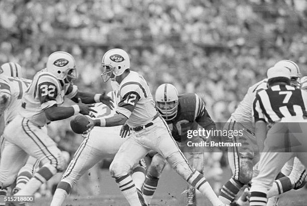 Miami, FL-New York Jets' Joe Namath hands off the ball to Emerson Boozer , during a Super Bowl game against the Colts in Miami. Joe's specialty is...