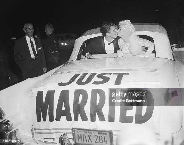 Palos Verdes, CA- Actress Jayne Mansfield receives a kiss from her bridegroom Mickey Hargitay following their wedding ceremony at the Glass...