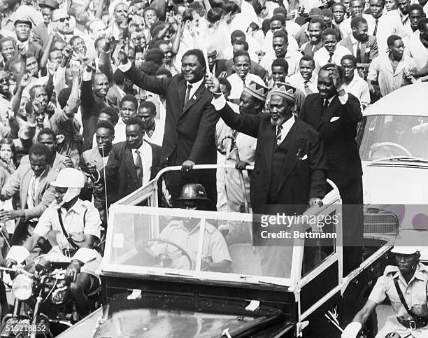 Nairobi, Kenya- Waving his "wisk" the newly-elected Premier of Kenya, Jomo Kenyatta, , greeted throngs of cheering citizens as he rode through the...