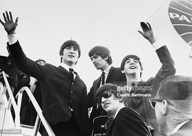 English rock 'n' roll sensations the Beatles - John Lennon, George Harrison, Paul McCartney, and Ringo Starr - wave to several hundred screaming fans...