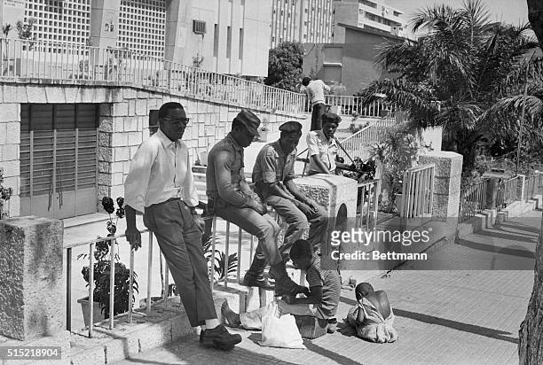 Luanda, Angola-An Angolan boy cleans the boots of a Cuban soldier in Luanda. Cuban troops helped the regime of Angola's Marxist President Agostinho...
