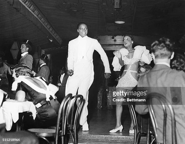 An audience at Harlem's Cotton Club, a popular night club, watches a performance.