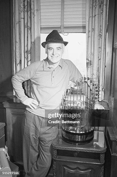 Insurance executive and Oakland Athletics owner Charles Finley stands in his insurance office next to one of the three consecutive World Series...