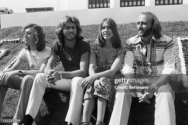 Sandy Farina sits among Maurice Gibb, Barry Gibb, and Robin Gibb of the Bee Gees while on the set of theSgt. Pepper's Lonely Hearts Club Band motion...