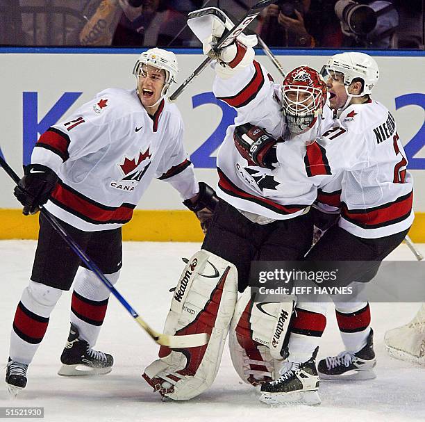 Canadian goalie Martin Brodeur celebrates with teammates Simon Gagne and Scott Niedermayer following their Men's Gold Medal Ice Hockey victory over...