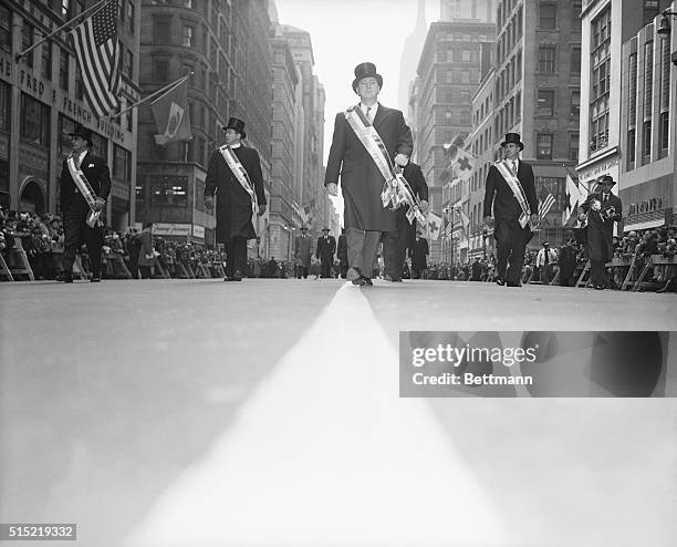 New York, New York-Police Commissioner George Patrick Monaghan, Grand Marshal of the St. Patrick's Day Parade, steps out on the street safety line...