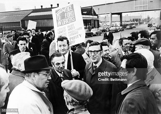 Dagenham, England- Leonard Woodcock , head of the United Auto Workers of the U.S., and UAW Vice President Ken Bannon , talk with picketeers outside...