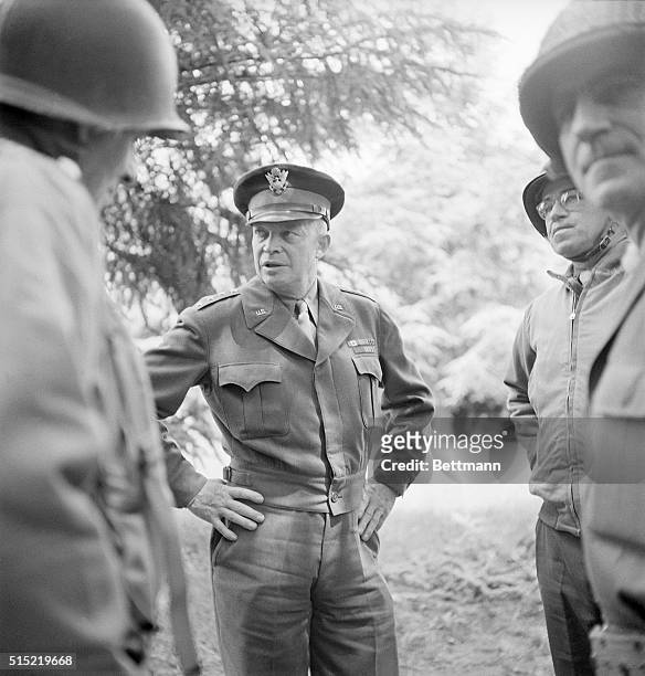 General Dwight D. Eisenhower talks with troops at the headquarters of the United States 1st Division in Normandy. The General also participated in...