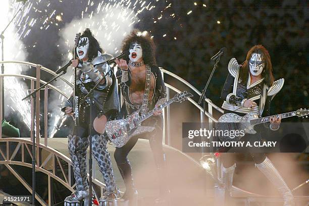 Members of 1970's US rock group "Kiss" perform during the closing ceremony of the XIXth Winter Olympic Games, 24 February 2002 at the Rice-Eccles...