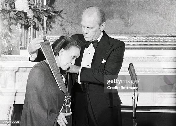 Washington, DC-President Ford places the Medal of Freedom around dancer Martha Graham's neck during a ceremony at the White House 10/15. The medal is...