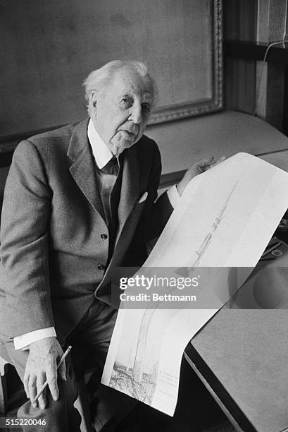 Leading American architect Frank Lloyd Wright holds a sketch of his mile-high office building which would rise 528 stories above Lake Michigan in...