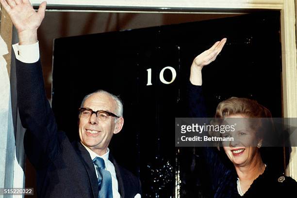 London, England: Britain's Prime Minister Margaret Thatcher, with her husband Dennis, wave from the door of 10 Downing on election day.