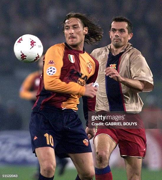 Roma midfielder Francesco Totti is chased by Barcelona's midfielder Dutch Philip Cocu during their Champions' League match AS Roma - FC Barcelona, at...