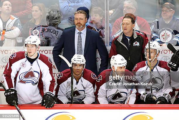 Head Coach Patrick Roy of the Colorado Avalanche looks on from the bench during second period action against the Winnipeg Jets at the MTS Centre on...