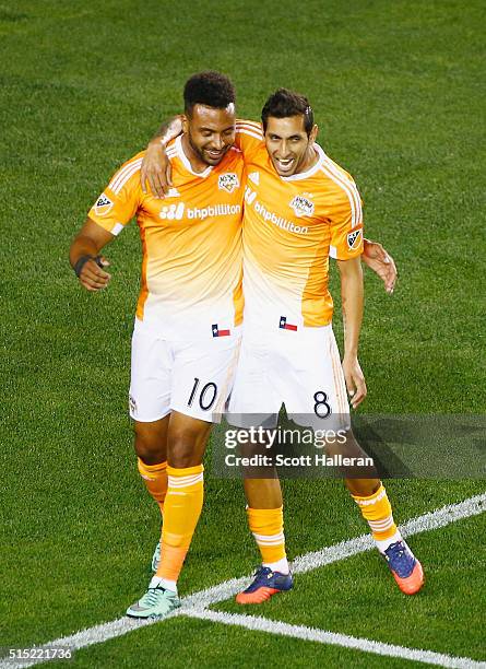 Giles Barnes and Cristian Maidana of the Houston Dynamo celebrate a first-half own goal against FC Dallas during their game at BBVA Compass Stadium...