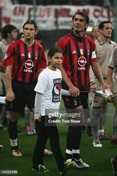 Paolo Maldini the Milan captain enters the pitch with a girl wearing a 'Unite Against Racism' shirt during the UEFA Champions League Group F match...