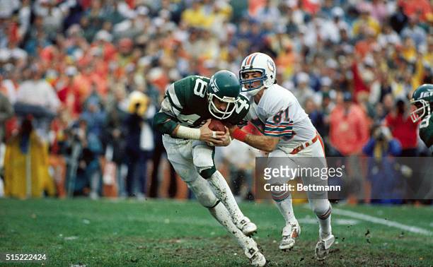 Miami, Florida: New York Jet safety Ken Schroy runs with the football he stole from Miami Dolphin Jimmy Cefalo by intercepting a first half pass,...