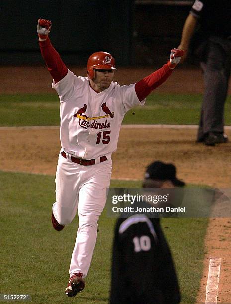 Jim Edmonds of the St. Louis Cardinals celebrates after hitting a game-winning two-run home run in the bottom of the 12th inning giving the Cardinals...