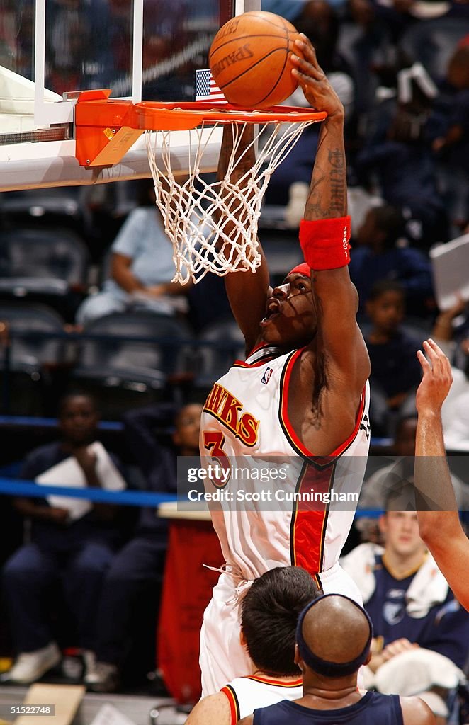 Al Harrington of the Atlanta Hawks dunks against the Memphis... News
