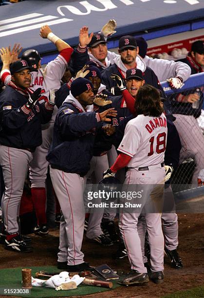 Johnny Damon of the Boston Red Sox celebrates with his teammates after hitting a grand-slam home run in the second inning against the New York...