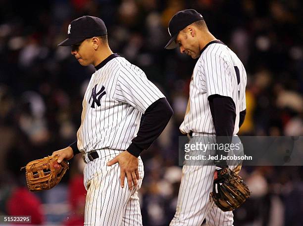 Alex Rodriguez and Derek Jeter of the New York Yankees walk back to the dugout after the end of the eighth inning against the Boston Red Sox during...