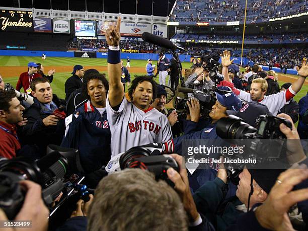 Manny Ramirez and Pedro Martinez of the Boston Red Sox celebrate after defeating the New York Yankees 10-3 to win game seven of the American League...