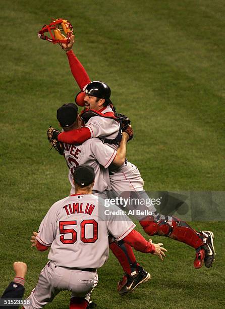 Alan Embree, Jason Varitek and Mike Timlin of the Boston Red Sox celebrate after defeating the New York Yankees 10-3 to win game seven of the...