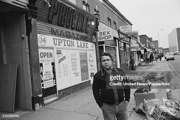 British magazine publisher and sex shop owner David Sullivan posed outside one of his Private shops in Upton Lane, East London on 8th February 1982.