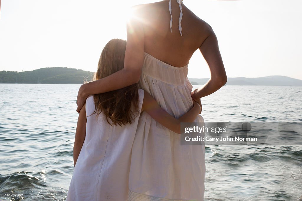 Mother and young daughter together by the sea